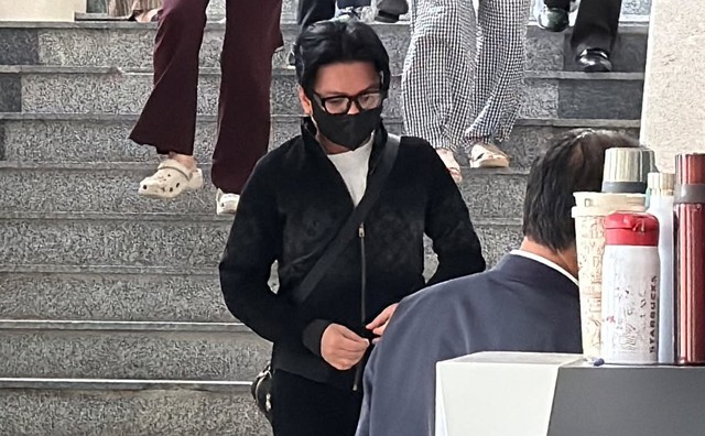 Tình hình của ca sĩ Vũ Hà- Ảnh 1. Vũ Hà đeo kính và khẩu trang đen xuất hiện tại Toà án nhân dân Hà Nội